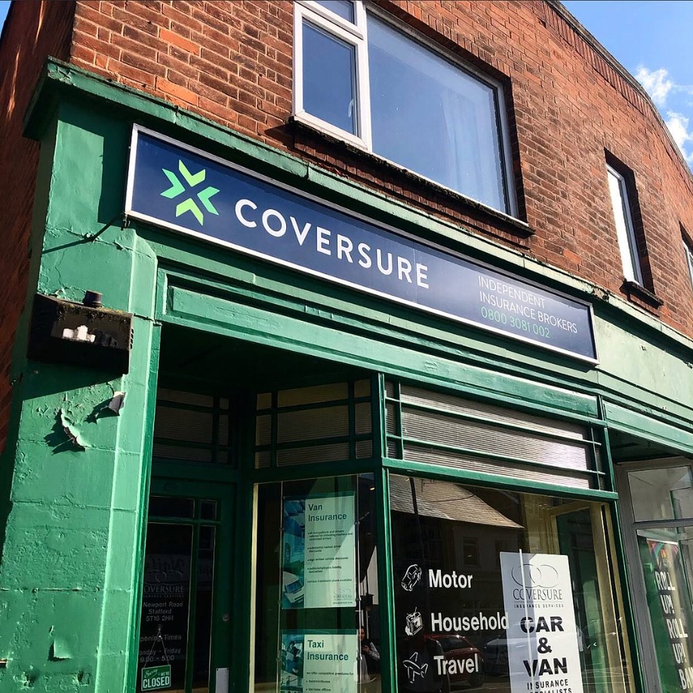 Printed shop fascia sign above a town centre shopfront produced by Vivid Design & Print Co in Stafford