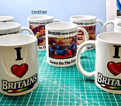Printed mugs with colourful farm-model photographs and Britains-themed designs