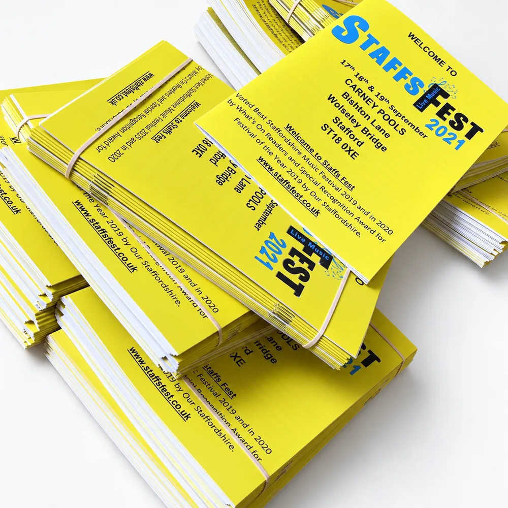 Stacks of bright yellow Staffs Fest programme booklets